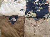 three men ' s polo shirts on a wooden crate