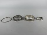 three silver rings and a silver ring on a white surface