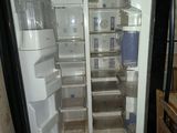 an open refrigerator with its door open in a kitchen