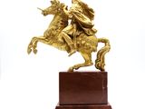 bronze statue of a man on a horse on a marble base