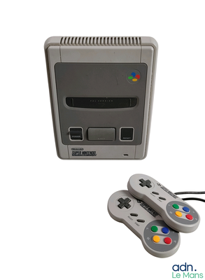 a nintendo classic game console with two controllers next to it