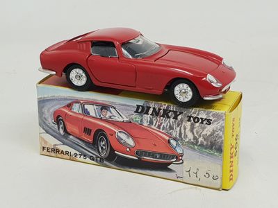 a red toy car sitting on top of a box