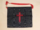 a black bag with a red cross on it