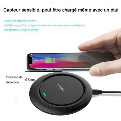 an image of a person holding a phone and charging a wireless device