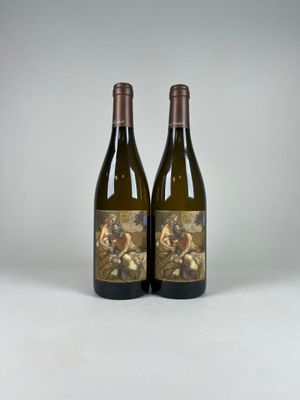 two bottles of wine sitting next to each other on a table