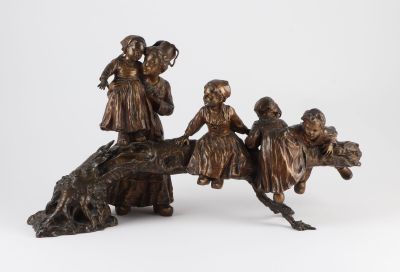 a bronze statue of a group of children riding on a horse