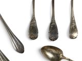five spoons and two spoon spoons on a white surface