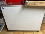 a white chest freezer sitting on a tiled floor