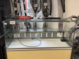 a glass display case in the middle of a room
