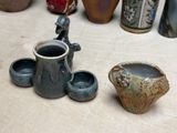 many different vases and bowls on the table
