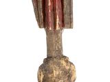 a small statue of a hand holding a red object