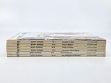 several books stacked on top of each other on a white surface