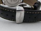 a close up of a watch on a white surface