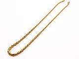 a close up of a gold necklace on a white background