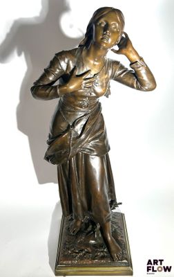 statue of a woman with a bird on her shoulder