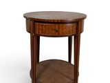an image of a round wooden table with a drawer underneath it