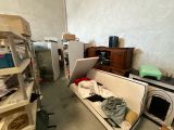 an image of a messy room with a couch and a refrigerator