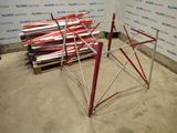 a pile of red and white fire extinguisors in a room