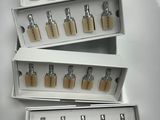 three boxes of perfumes are stacked on top of each other on a table
