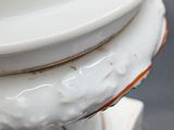 a close up of a vase with a flower design on it