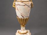 an image of a white and gold vase sitting on top of a table