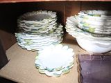 many plates and bowls sitting on a table