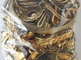 a bag full of gold and silver jewelry on a table