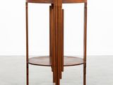 a round wooden table with a wooden top and two shelves