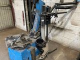 a blue machine that is sitting in a garage