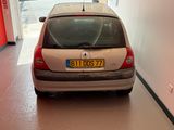 a silver car parked in a building with a red door