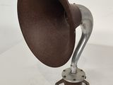 a brown and silver object on a white surface
