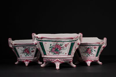 three vases with flowers on them on a table
