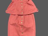 an image of a pink dress with buttons on the shoulders