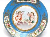 a blue plate with a picture of two cherensils on it