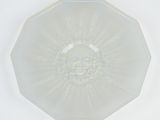 a clear glass plate with a sun design on it