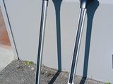 two crutches sitting on the ground next to a wall
