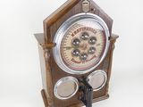 a wooden clock that is on display on a table