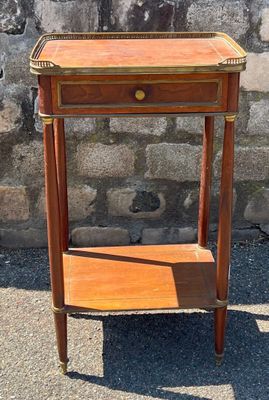 a small wooden table with a drawer on top of it