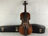 a violin that is sitting next to a case