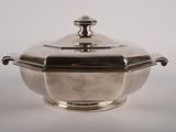 an antique silverplated bowl with a lid on a white background