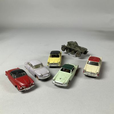 several toy cars are lined up in a circle on a white surface