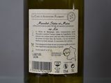 a bottle of wine sitting on a table with a label on it