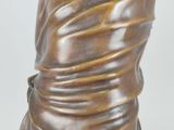 bronze statue of a woman with a shaw around her neck