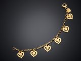 a gold bracelet with heart charms on a black background