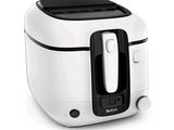 a white and black air fryer sitting on a white surface