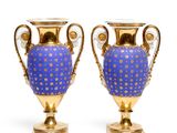 pair of blue and gold vases sitting on top of each other