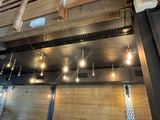 many light bulbs hanging from the ceiling of a restaurant