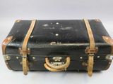 a black suitcase that is sitting on a white surface