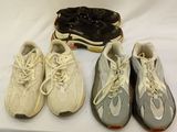 trois paires de chaussures de tennis et une boîte à chaussures posées sur une table