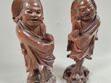 pair of chinese carved wood figurines of a boy and a girl
